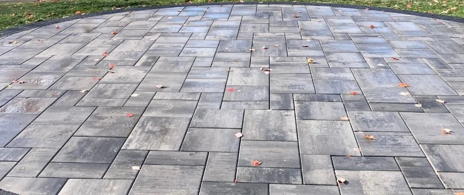 Circular patio in Newton, MA, made of concrete pavers.