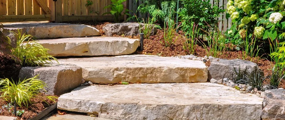 Outdoor steps leading up to a fence.