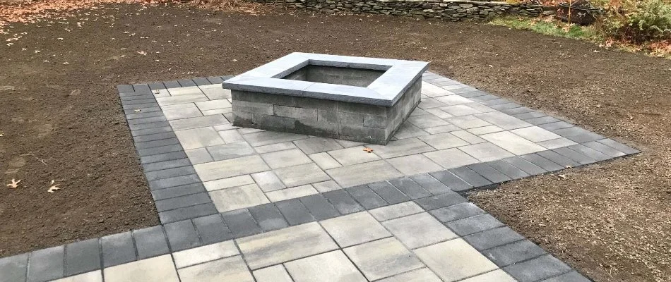 Paver patio with a fire pit in Worcester, MA.
