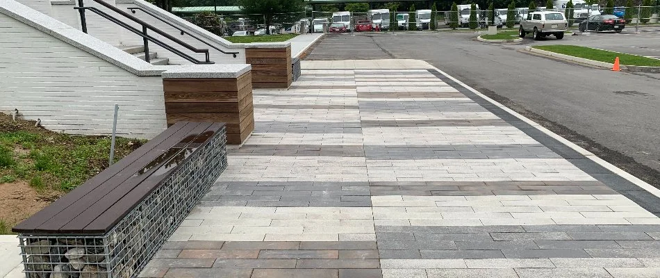 Paver walkway in Newton, MA, with a bench and steps.