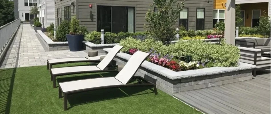 Lawn chairs and landscaping on rooftop in Boston, MA.
