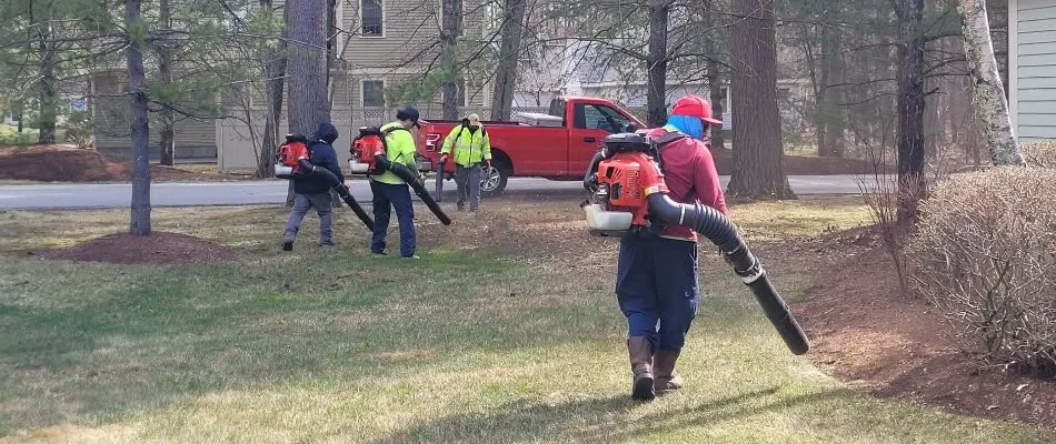 Workers using blowers for a yard in Boston, MA.
