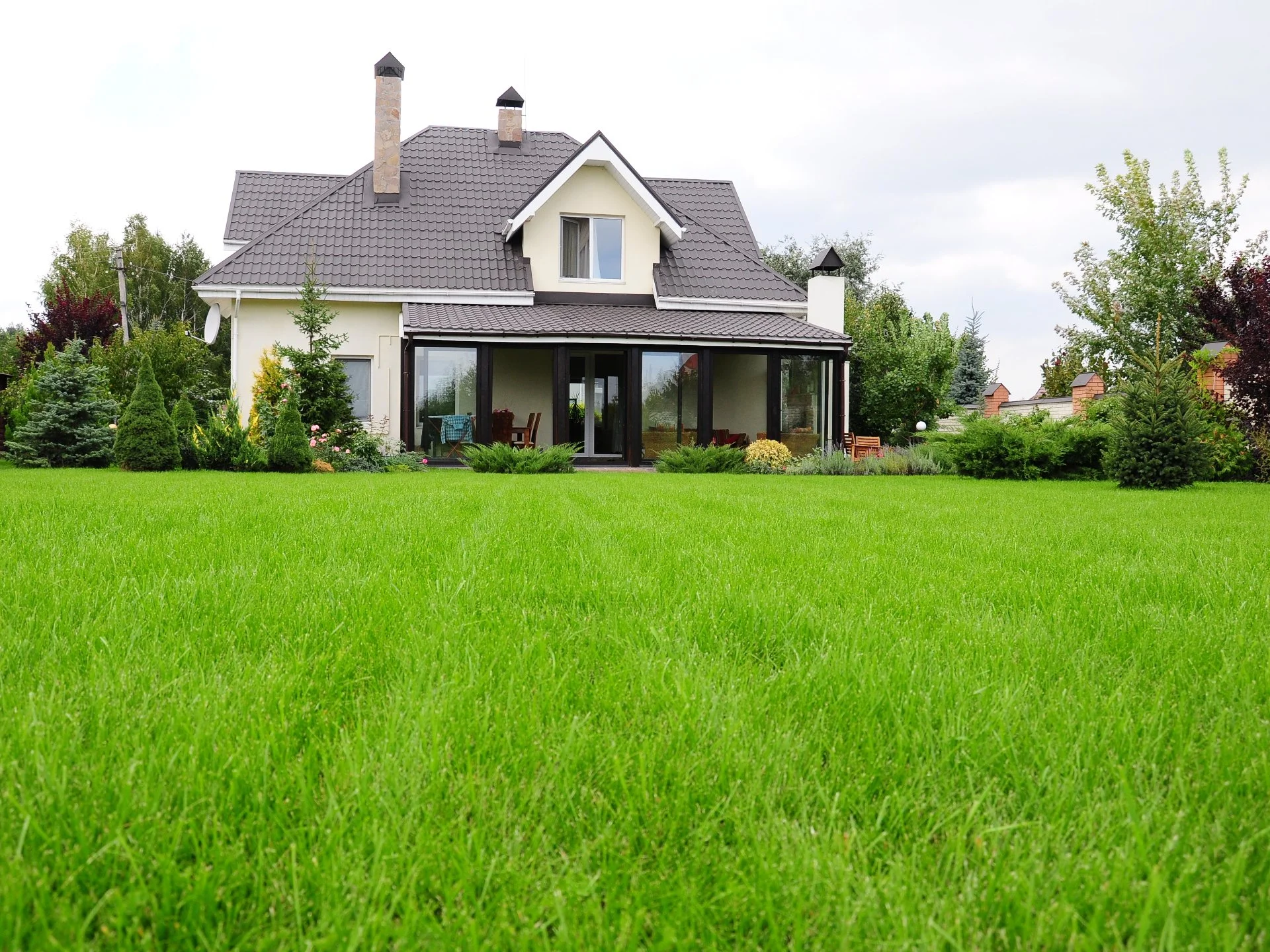 Healthy green lawn with modern house in Boston, MA.